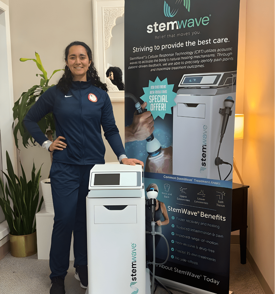 Person standing next to a Stemwave ozone generator and promotional banner.